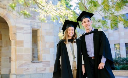 Spot the plastic bottles: The new graduation gowns at UQ are made from 100 per cent recycled plastic bottles. Modelled by July graduating students Hannah Hardy and Casey Fung.